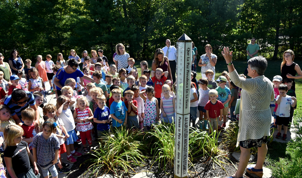 Kennebec Montessori students gather around the school's peace pole at their campus as they recognize National Day of Peace on Sept. 21 in Fairfield. The school is set to receive a $700,000 loan from the U.S. Department of Agriculture to build an addition to the school for expanded upper elementary-level classes.
