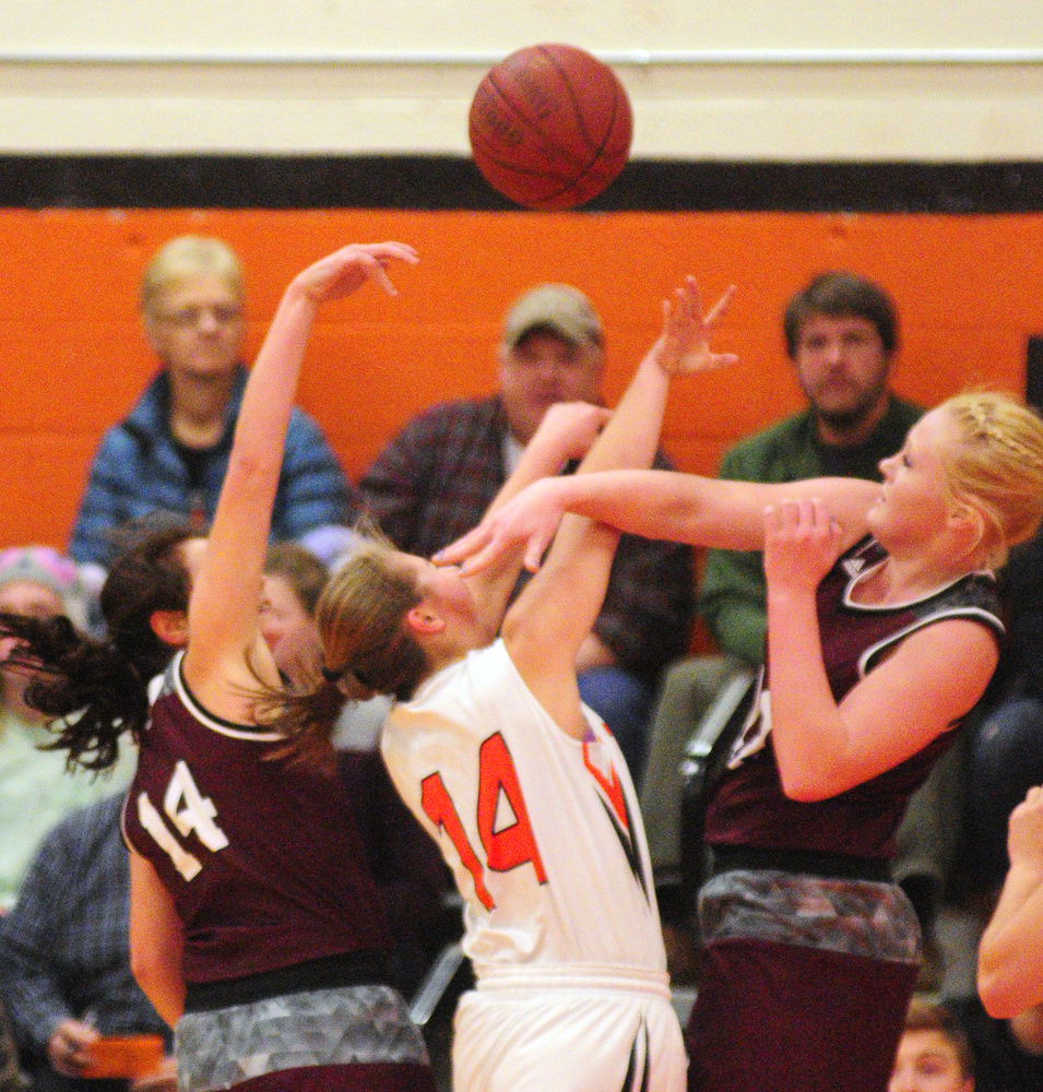 Nokomis defenders Chelsea Crockett, left, and Gabrielle Lord, right, converge on Gardiner junior guard Logan Granholm during a Kennebec Valley Athletic Conference Class A game Friday night in the James A. Bragoli Memorial Gym in Gardiner.