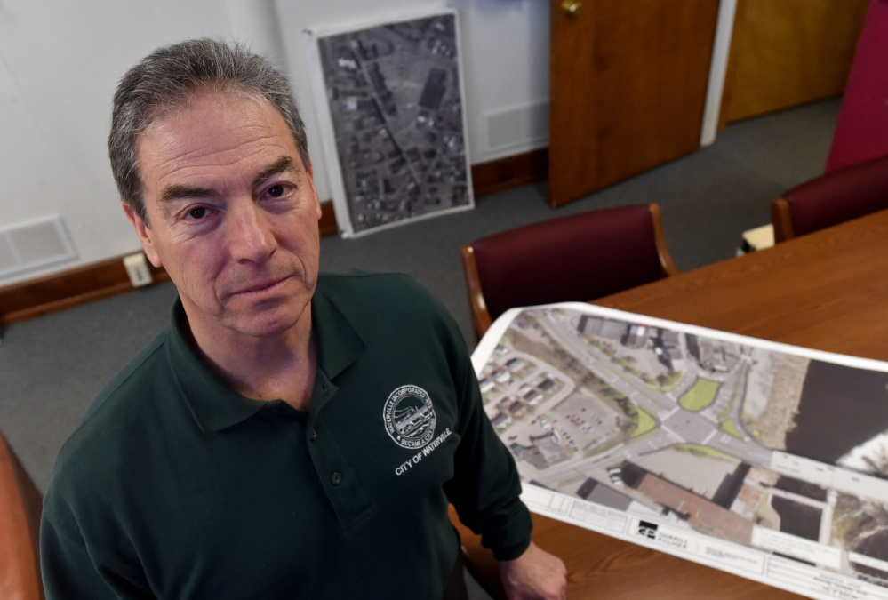 Mike Roy, Waterville's city manager, poses for a portrait Friday at his office with a rendering of the proposed traffic plans for downtown Waterville.