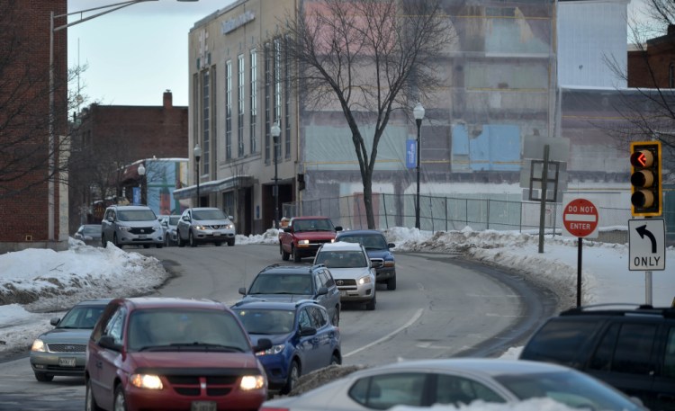 Traffic flows south Friday on Main Street toward the Bridge Street intersection in Waterville. A new traffic study proposes how two-way traffic could resume on Main Street as part of downtown revitalization efforts.