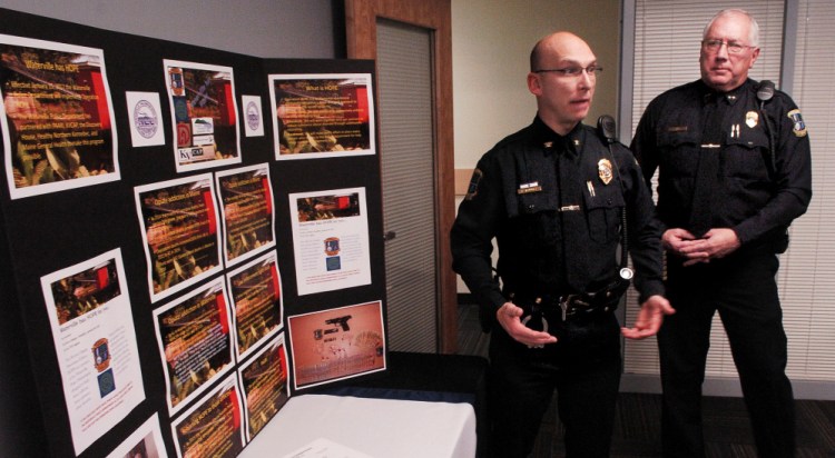 Waterville police Deputy Chief Bill Bonney, left, and Chief Joe Massey speak beside a display of opiate drugs and statistics on the increase of drug use Nov. 16 during a news conference at which authorities announced Operation HOPE, a program that aims to help drug addicts get treatment. Volunteer "angels" soon will meet with program participants to help them find treatment and recover.