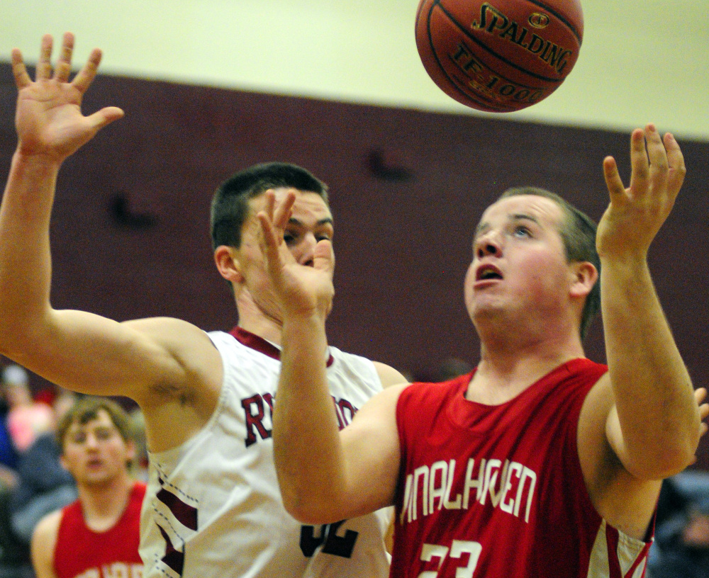 Richmond's Matt Holt, left, and Vinalhaven's Cody Hamilton go for a rebound during a game Friday in Richmond.