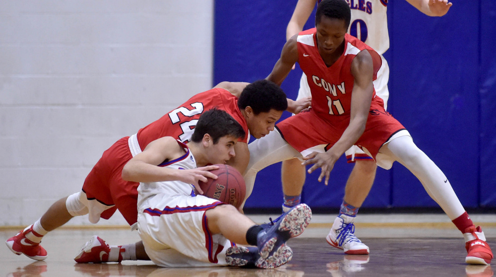 Messalonskee's Chase Warren, foreground, battles for the loose ball with Cony's Jordan Roddy (24) and Amahde Carter (24) on Saturday in Oakland.