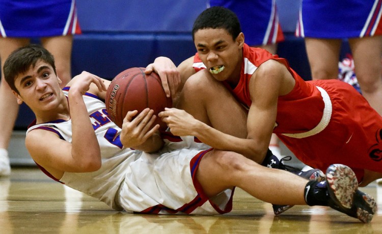 Messalonskee's Chase Warren, left, battles for the loose ball with Cony's James Hunt on Saturday in Oakland.