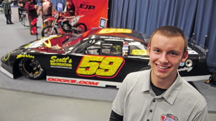 Staff photo by Joe Phelan 
 Reid Lanpher poses beside his race car during the Northeast Motorsports Expo on Saturday at the Augusta Civic Center.