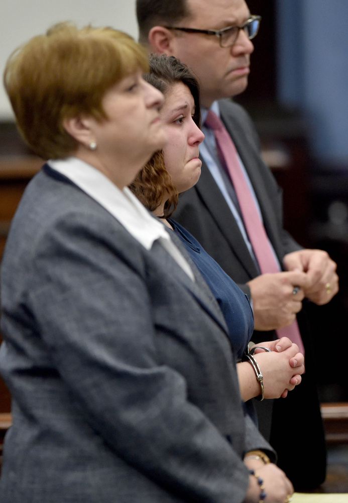 Kayla Stewart, center, reacts to her sentencing from Judge Robert Murray as she stands with her attorneys Pamela Ames, left, and John Martin, back right, at Somerset Superior Court in Skowhegan on Jan. 4. Stewart pleaded guilty to manslaughter in connection with the killing of her infant baby just over a year ago.