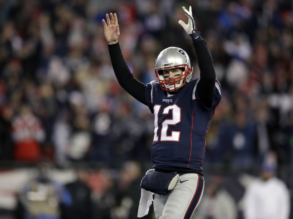 New England Patriots quarterback Tom Brady celebrates a touchdown by running back Dion Lewis during the second half of an NFL divisional playoff game Saturday against the Houston Texans in Foxborough, Massachusetts.
