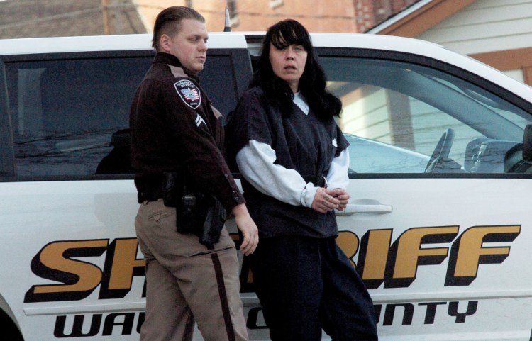 Miranda Hopkins, of Troy, is led into Belfast District Court on Tuesday for an initial appearance on a charge of murder in connection with the death of her 7-week-old son.