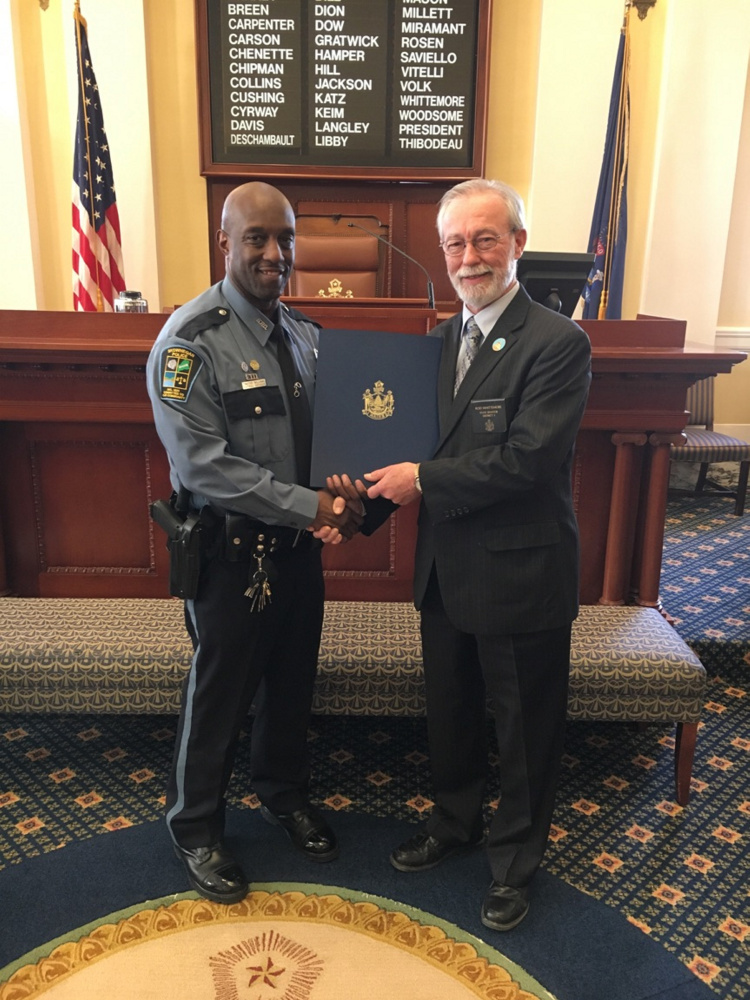 Officer Tim Williams, left, was recently presented with a Legislative Sentiment by Sen. Rodney Whittemore .