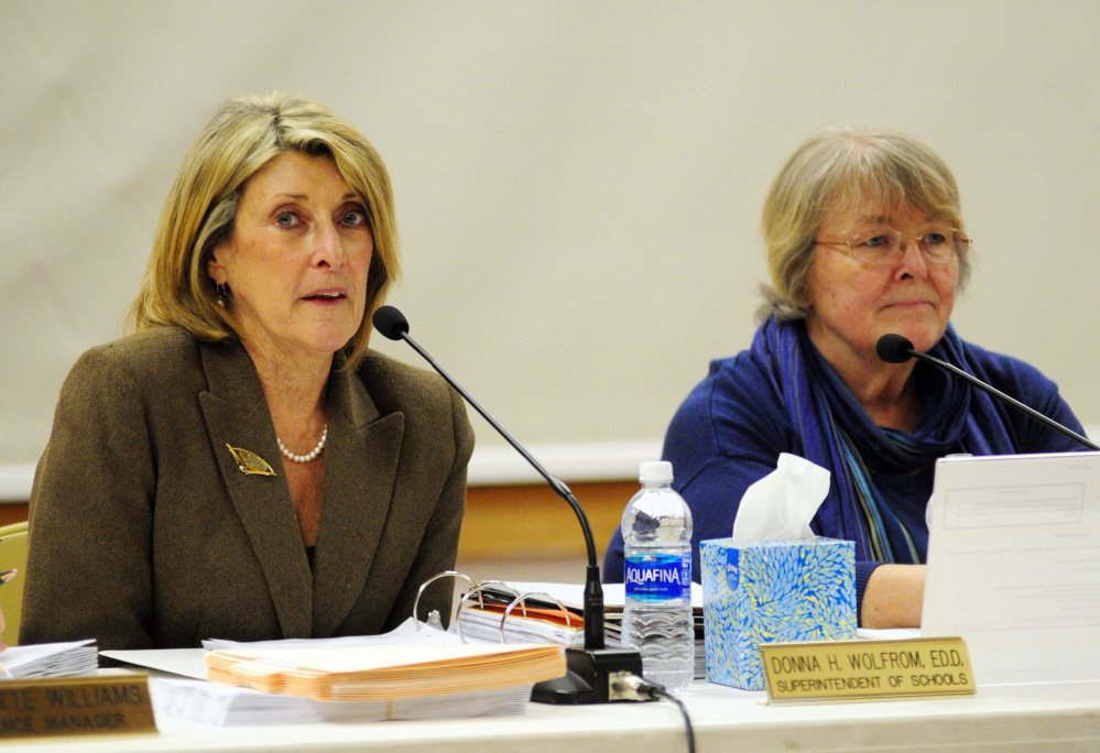 Superintendent Donna Wolfrom, left, speaks beside board Chairwoman Terri Watson during a Regional School Unit 38 board meeting Wednesday at Maranacook Community School in Readfield, where parents and teachers expressed concern about mold at Manchester Elementary School.