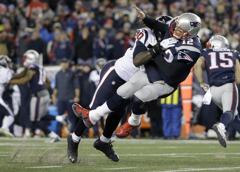 Houston Texans defensive end Jadeveon Clowney levels New England quarterback Tom Brady after Brady released a pass during the first half of a divisional playoff game in Foxborough, Massachusets last weekend.