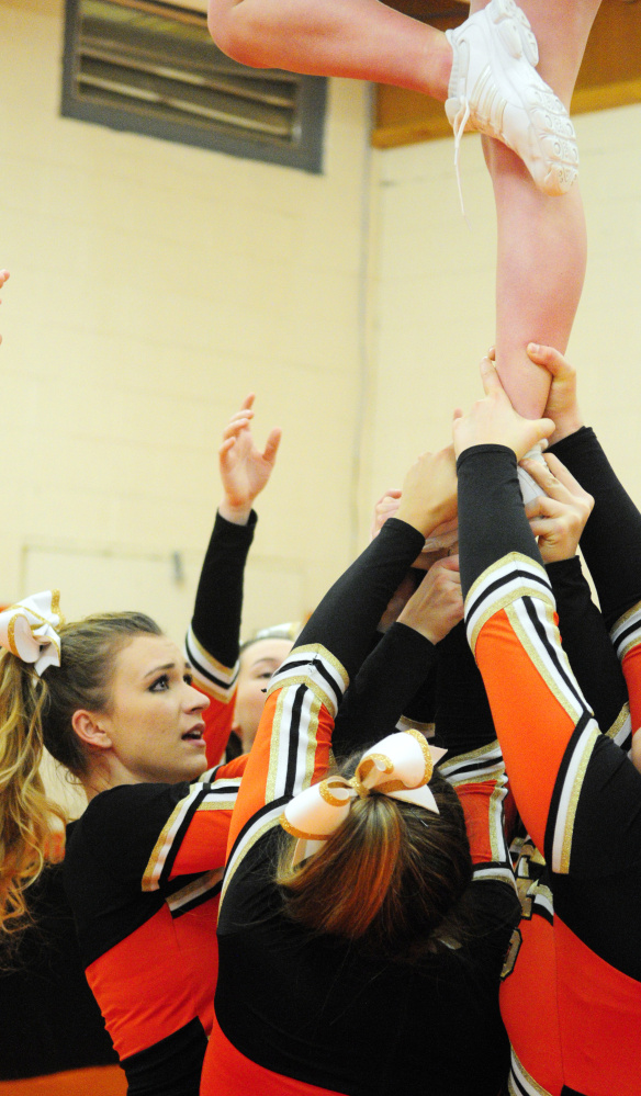 Sierra Goodridge, left, and her Tiger teammates practice a cheerleading routine Friday at Gardiner Area High School.