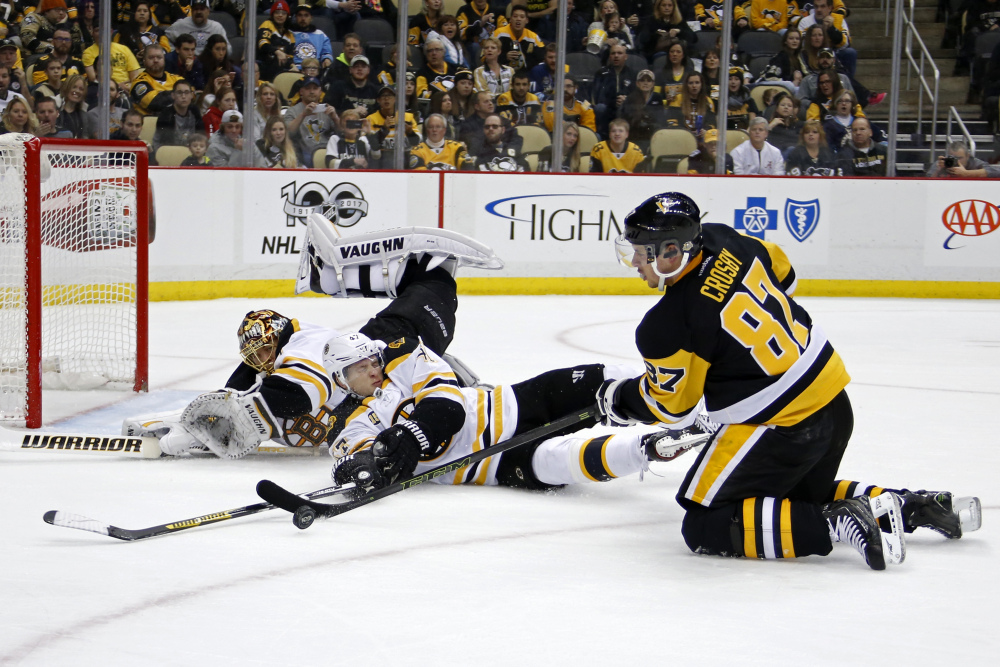 Pittsburgh's Sidney Crosby (87) tries to shoot in front of Boston's Torey Krug (47) and goalie Tuukka Rask, rear, during the second period Sunday in Pittsburgh.