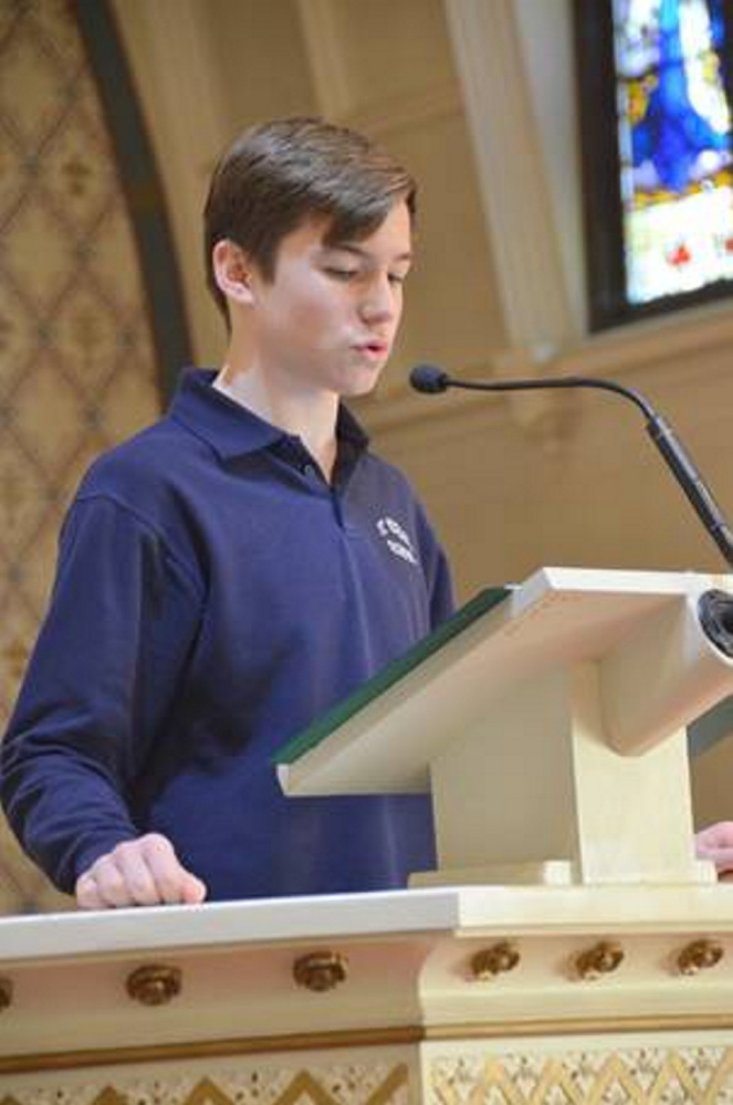 Camden Cotnoir speaks during Mass at the Assumption Church.