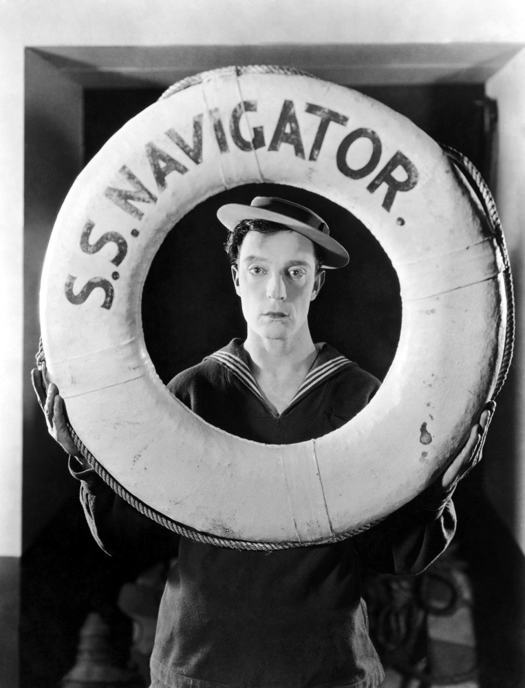 Actor and director Buster Keaton wearing a sailor suit and holding a life preserver from the film, "The Navigator," directed by Keaton and Donald Crisp.