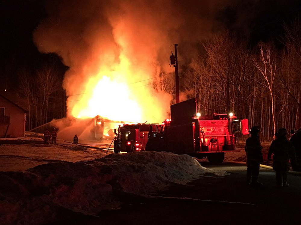 A two-bay garage in Manchester was destroyed by fire Monday night, but firefighters were able to prevent the blaze from spreading to the house on Friendship Drive.