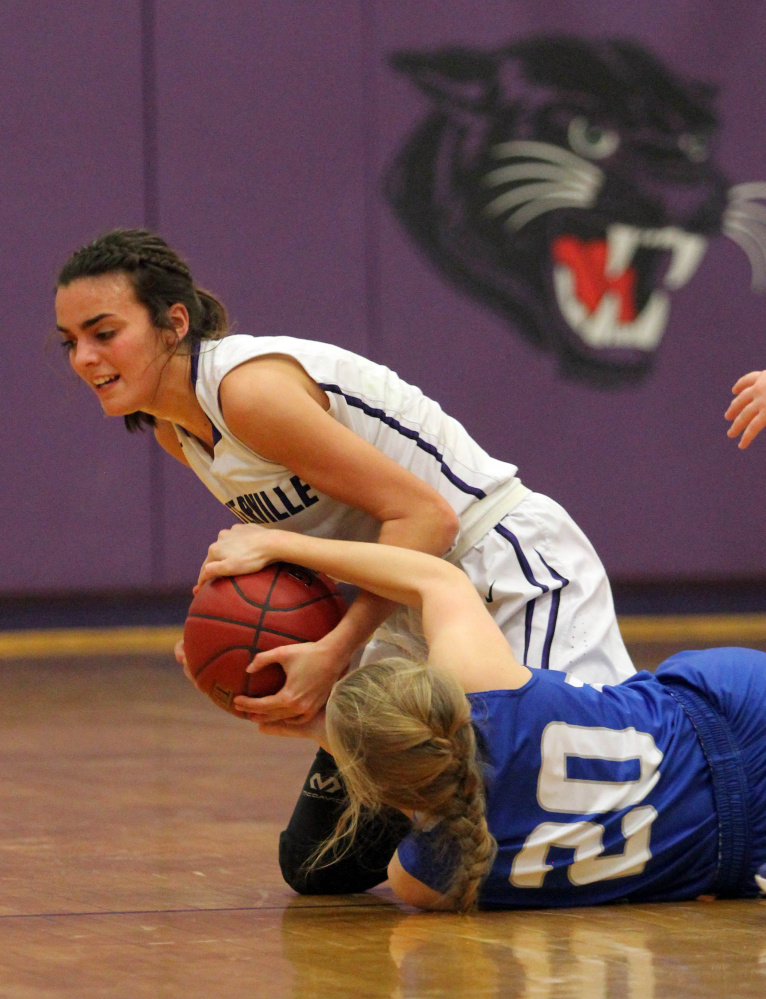 Waterville's Jordan Jabar, top, battles for the ball with Lawrence's Keagan Alley during first-half action Wednesday in Waterville.