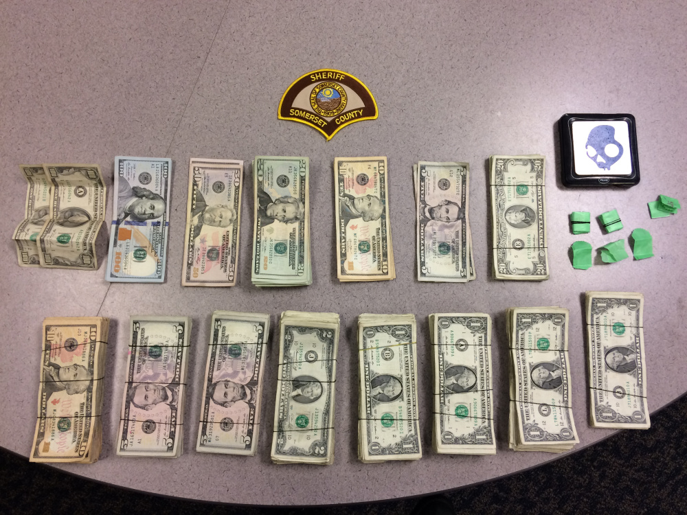 About $4,700 in cash and bags of heroin, seen here in a photo provided by the Somerset County Sheriff's Office, were seized Thursday in a raid in Madison.