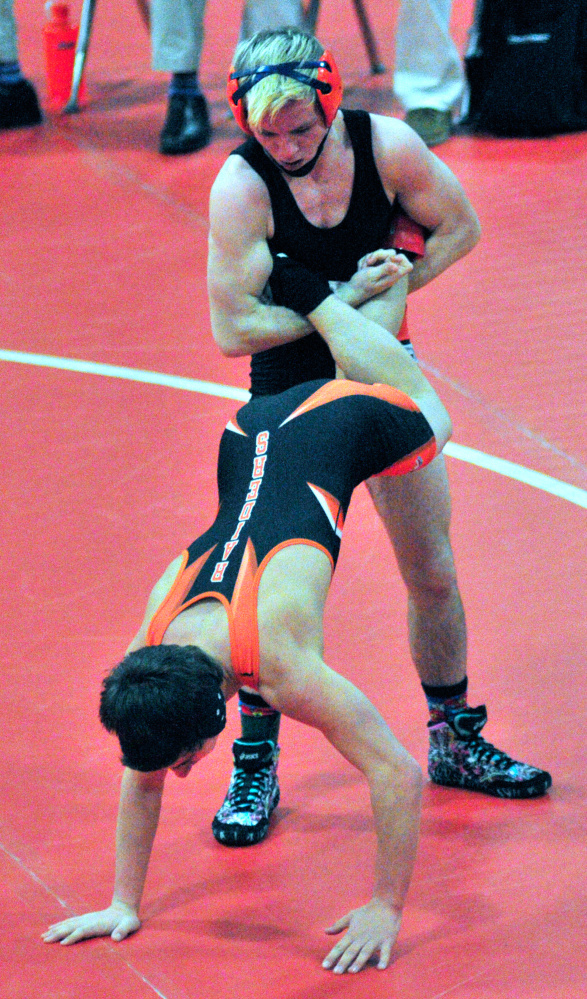 Skowhegan's Cody Craig, top, looks to bring down Winslow's Devon Vigue during the 113-pound finals at the Kennebec Valley Athletic Conference Class A championships last season at Cony High School.
