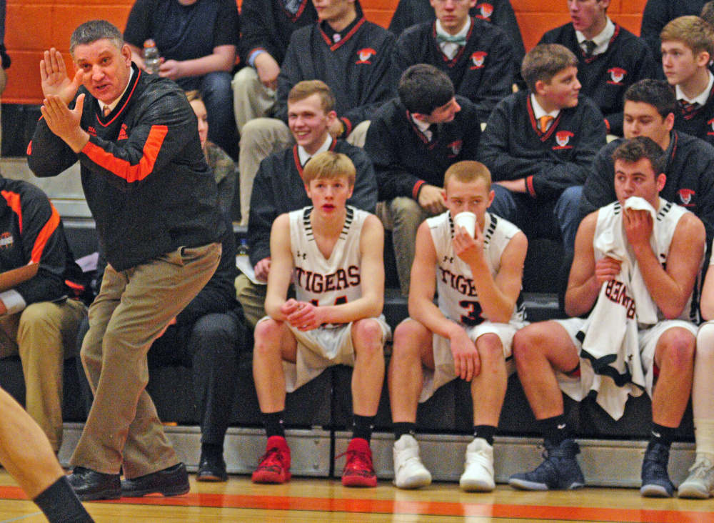 Staff photo by Joe Phelan 
 Charlie Lawrence coaches the Tigers during a game against Hampden on Tuesday in Gardiner.
