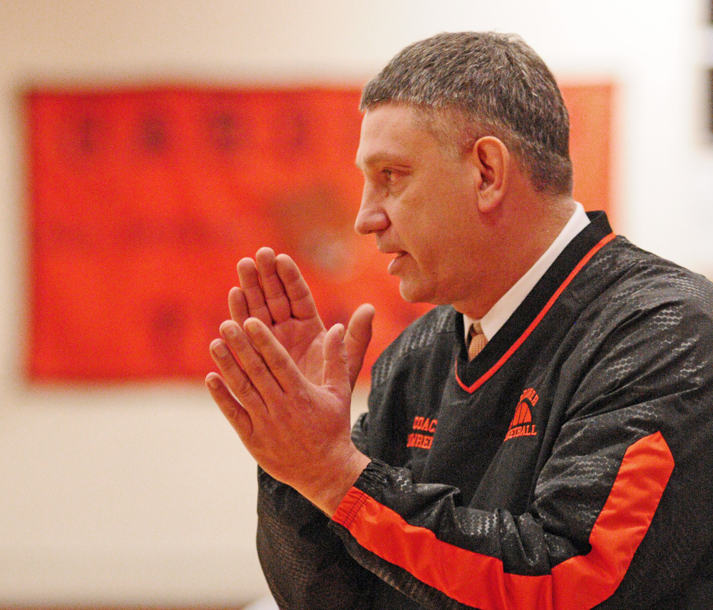 Staff photo by Joe Phelan 
 Charlie Lawrence coaches the Tigers during a game against Hampden on Tuesday in Gardiner.