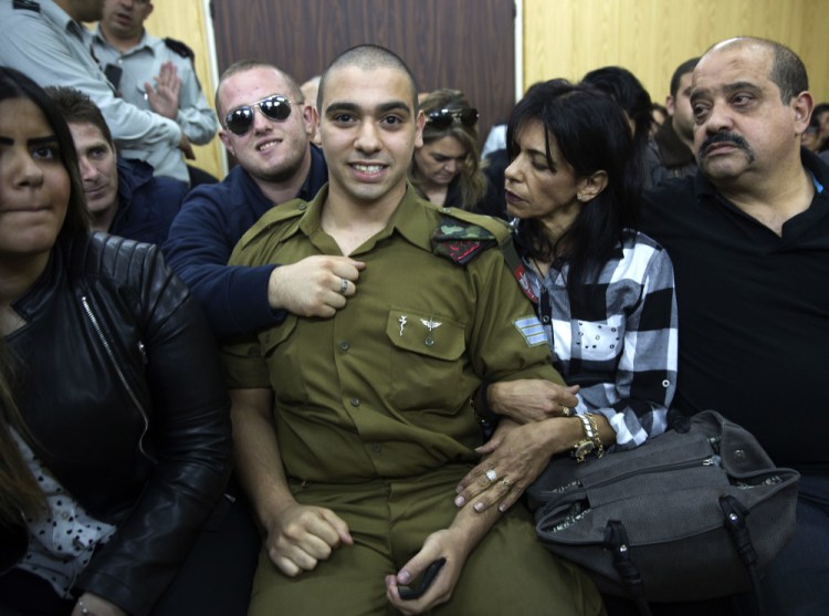 Israeli soldier Sgt. Elor Azaria waits with his parents for the verdict inside the military court in Tel Aviv on Wednesday <em>Heidi Levine via AP</em>