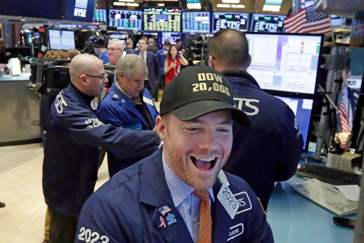 Specialist Frank Masiello wears a Dow 20,000 cap as he works on the floor of the New York Stock Exchange Wednesday. 