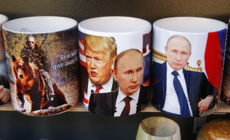 Cups depicting Russian President Vladimir Putin and President Trump for sale in St. Petersburg, Russia. The two leaders are set to talk Saturday. 