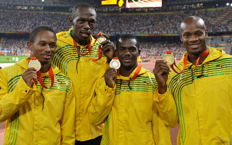 Jamaica's men's 4x100 meters relay team, from left, Michael Fraser, Usain Bolt, Nesta Carter and Asafa Powell show their gold medals during the athletics competitions in the National Stadium  at the Beijing 2008 Olympics.