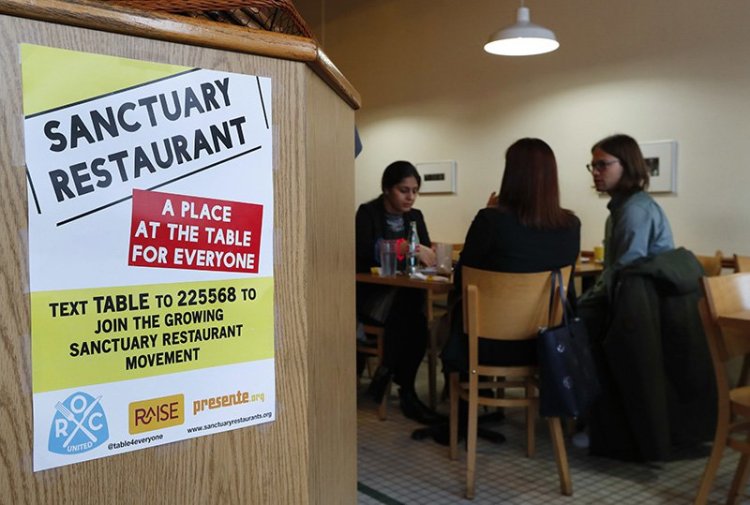 A sanctuary restaurant sign is shown inside Russell Street Deli in Detroit. 
