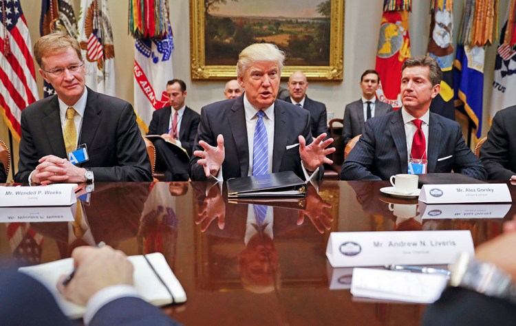 President Trump hosts a breakfast with business leaders in the Roosevelt Room of the White House Monday. At left is Wendell P. Weeks, CEO of Corning; at right is Alex Gorsky, chairman and CEO of Johnson & Johnson. 