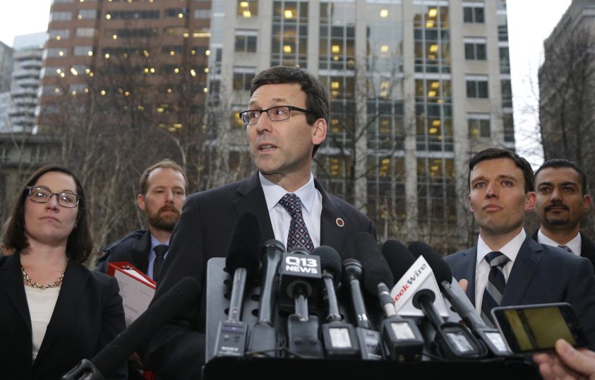 Washington Attorney General Bob Ferguson, center, talks to reporters Friday as Solicitor General Noah Purcell, second from right, looks on after a federal judge in Seattle temporarily blocked President Trump's ban on people from seven predominantly Muslim countries from entering the United States. Washington state and Minnesota urged a nationwide hold on the executive order.