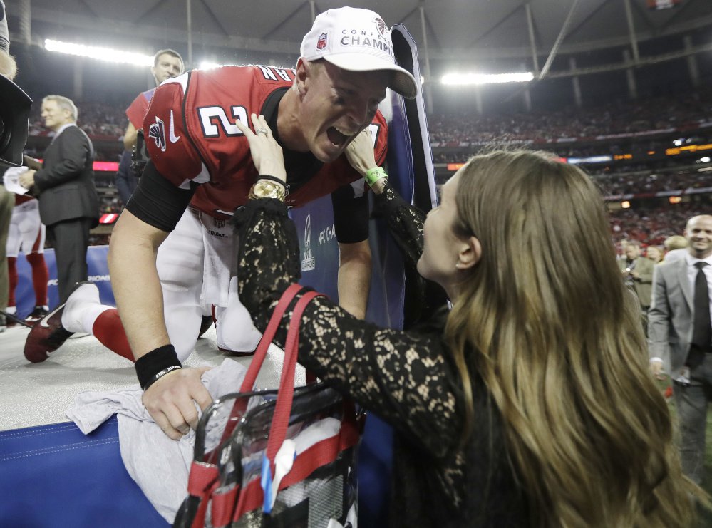 Falcons quarterback Matt Ryan embraces his wife, Sarah – a Falmouth native – after Atlanta's victory over Green Bay in the NFC championship game on Jan. 22.