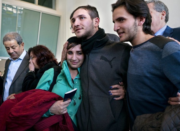 Tawfik Assali, 21, center, of Allentown, Pa., embraces his sister Sarah Assali, 19, upon her and other family members' arrival from Syria at at John F. Kennedy International Airport in New York on Monday. At right is Mathew Assali, 17, who arrived Monday. Attorneys said members of the Assali family returned to Syria after they were denied entrance to the United States on Jan. 28 although they had visas in hand after a 13-year effort.