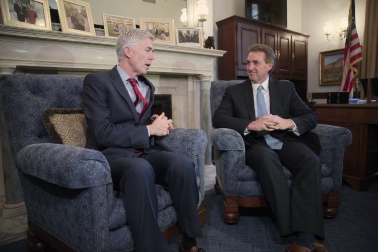 Supreme Court justice nominee Neil Gorsuch meets with Senate Judiciary Committee member Jeff Flake, R-Ariz., on Wednesday on Capitol Hill. Gorsuch told lawmakers that President Trump's attacks on the judiciary are "disheartening" to the independence of the federal courts.