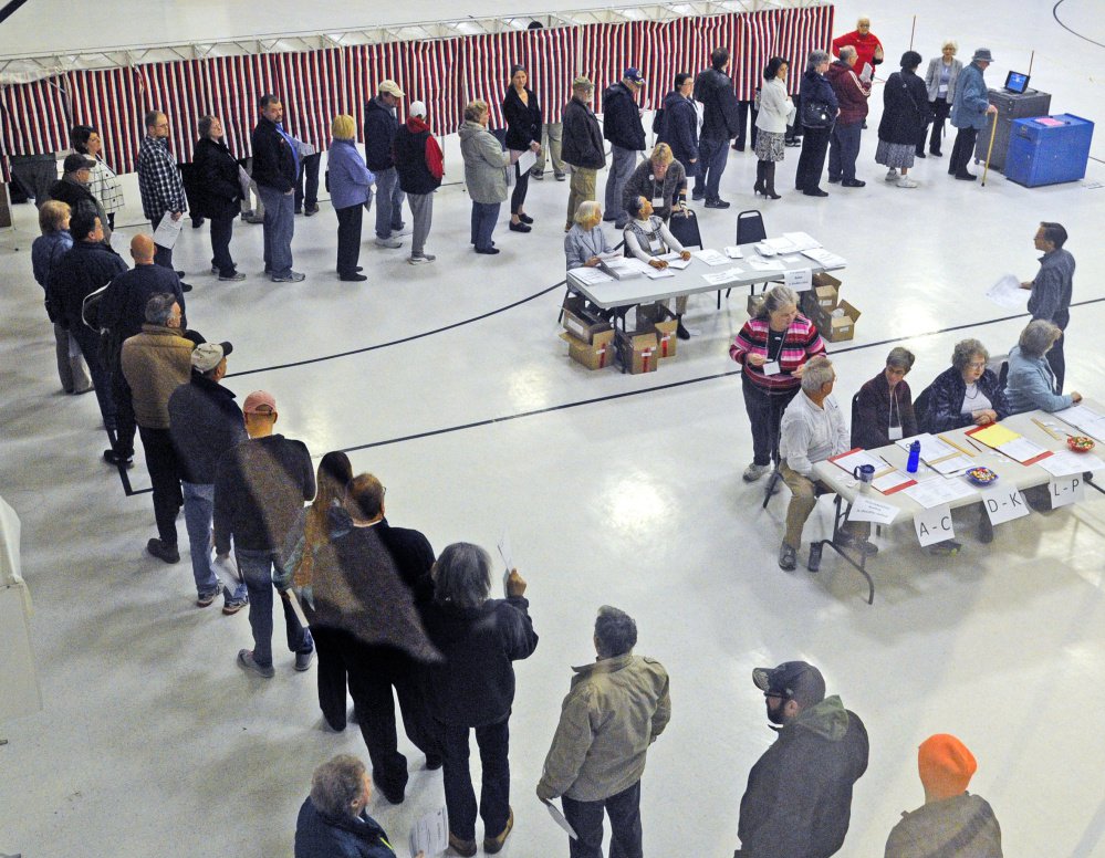 Voters wait to cast ballots in Augusta on Election Day, 2016. Efforts are underway in Maine and other states to adopt or tighten requirement to show identification at the polls.