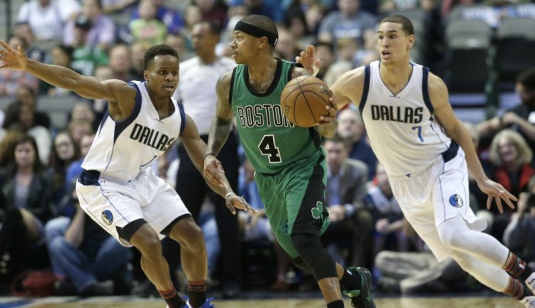 Celtics guard Isaiah Thomas dribbles against Mavericks defenders Yogi Ferrell (11) and Dwight Powell in the first half. Thomas finished with 29 points and the Celtics got another win.