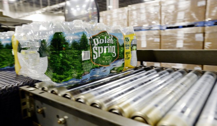 Packaged bottles of Poland Spring water move down a conveyer belt at the company's plant in Hollis. Poland Spring is one of the top private employers in Maine, with more than 900 workers in the state at its peak in 2016.