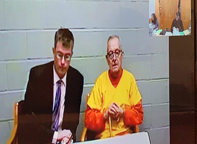 Randall Bates, left, represented former Boston priest and convicted child molester Ronald Paquin on Friday in Biddeford District Court during Paquin's initial hearing by video on 29 charges of sexual assault on two boys in the 1980s.