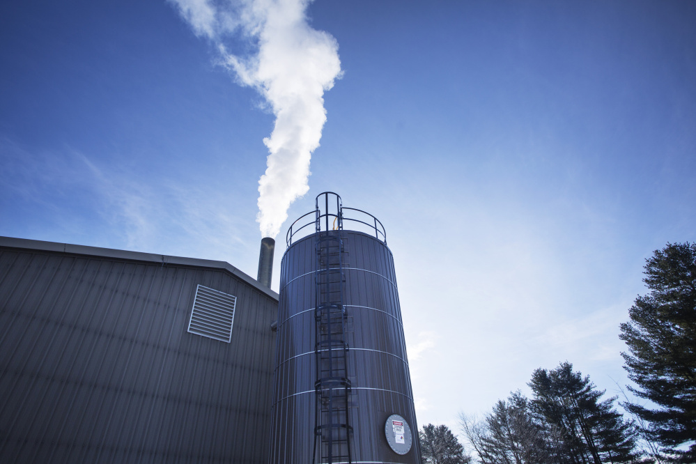 Boiler exhaust rises from a smokestack at Bates College in Lewiston. The school is using wood-derived fuel from Ensyn Corp. in Canada to heat 70 percent of campus buildings. Delivery trucks fill its 20,000-gallon fuel tank five or six times a week.