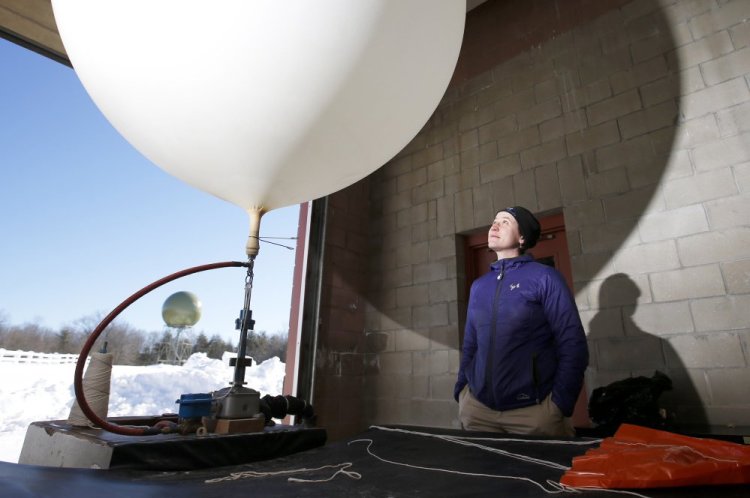 Margaret Curtis and her fellow forecasters  launch weather balloons to collect data.