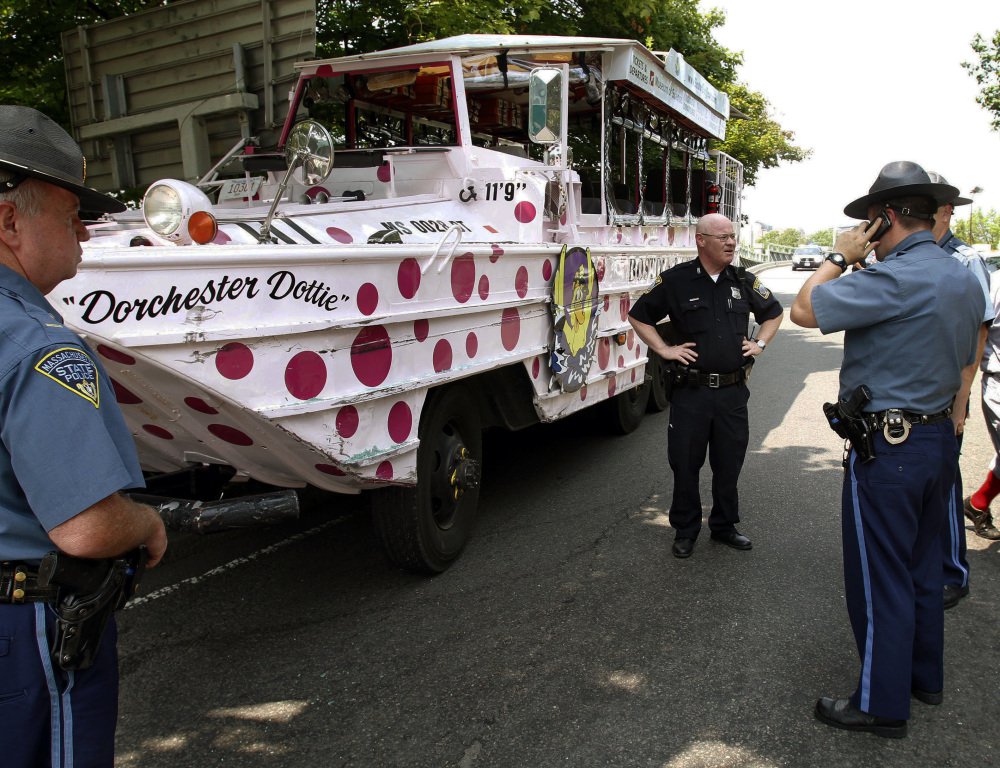 Boston police officers work the site of a crash involving an amphibious duck boat in June 2010 that left some passengers with minor injuries. New safety regulations are set to go into effect in April after a duck boat ran over and killed a 28-year-old woman last spring.