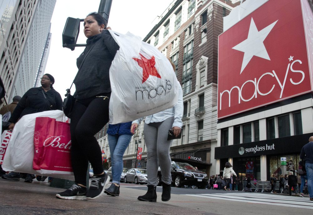 Shoppers cross near Macy's in New York City. As consumers buy more online, the nation's largest department store chain has aggressively shuttered stores while trying to adapt its brand and Web presence.