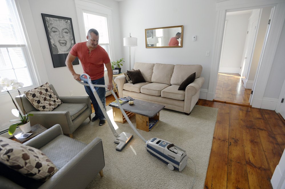 PORTLAND, ME - OCTOBER 8: Gary Wagner vaccums the half of his home he rents out on Airbnb after guests had left Thursday, October 8, 2015. (Photo by Shawn Patrick Ouellette/Staff Photographer)
