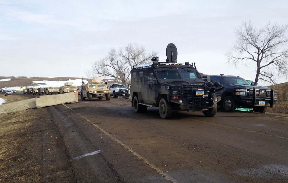 Law enforcement vehicles arrive at the closed Dakota Access pipeline protest camp near Cannon Ball, N.D., on Thursday, where dozens of people remained. Most protesters left peacefully Wednesday.