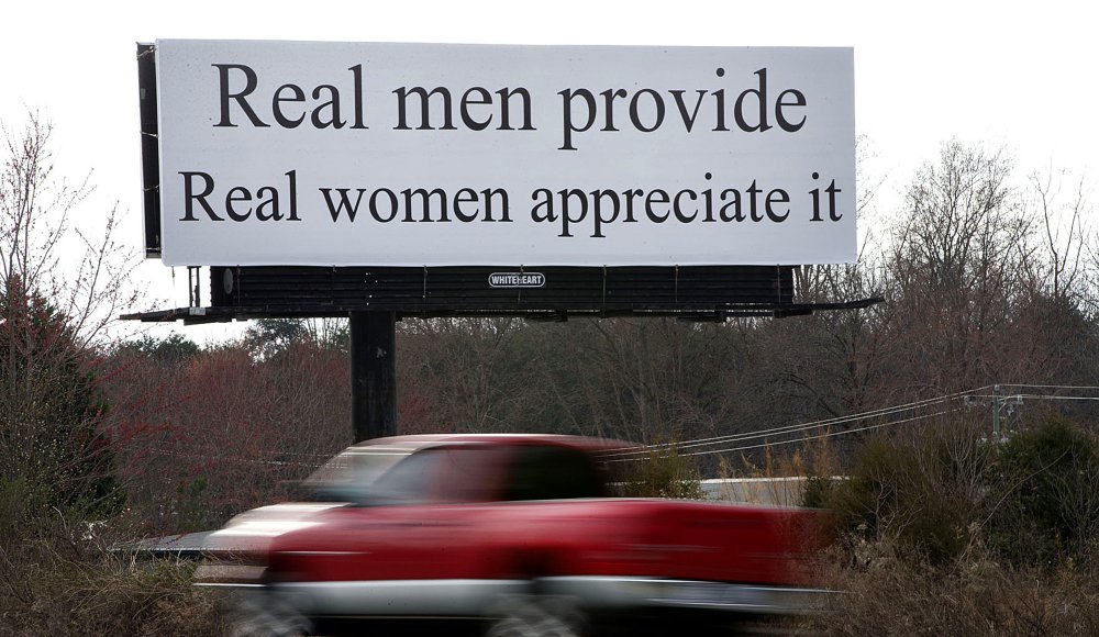 The billboard between Winston-Salem and Greensboro reads, "Real men provide. Real women appreciate it." Women are planning to protest the message Sunday.