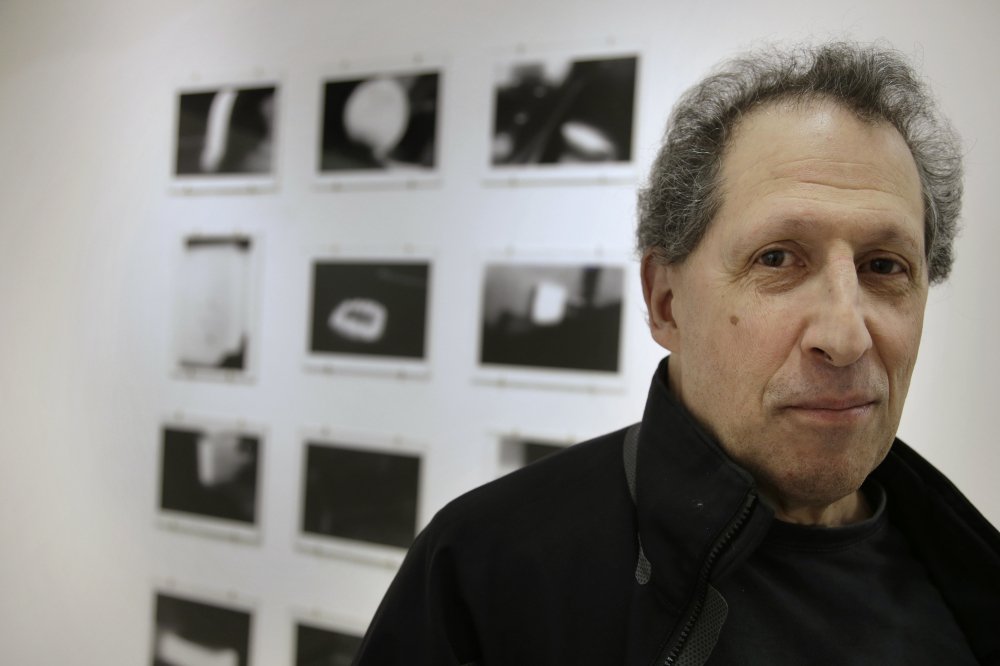Photographer Karl Baden of Cambridge, Mass., stands in front of an exhibit of his photographs from 1976 called "Thermographs," at the Miller Yezerski Gallery in Boston.