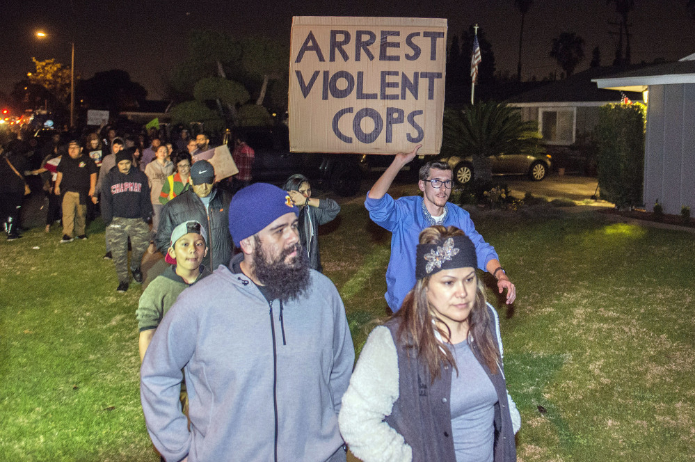 Hundreds of demonstrators march toward an off-duty police officer's home in Anaheim, Calif., late Wednesday.