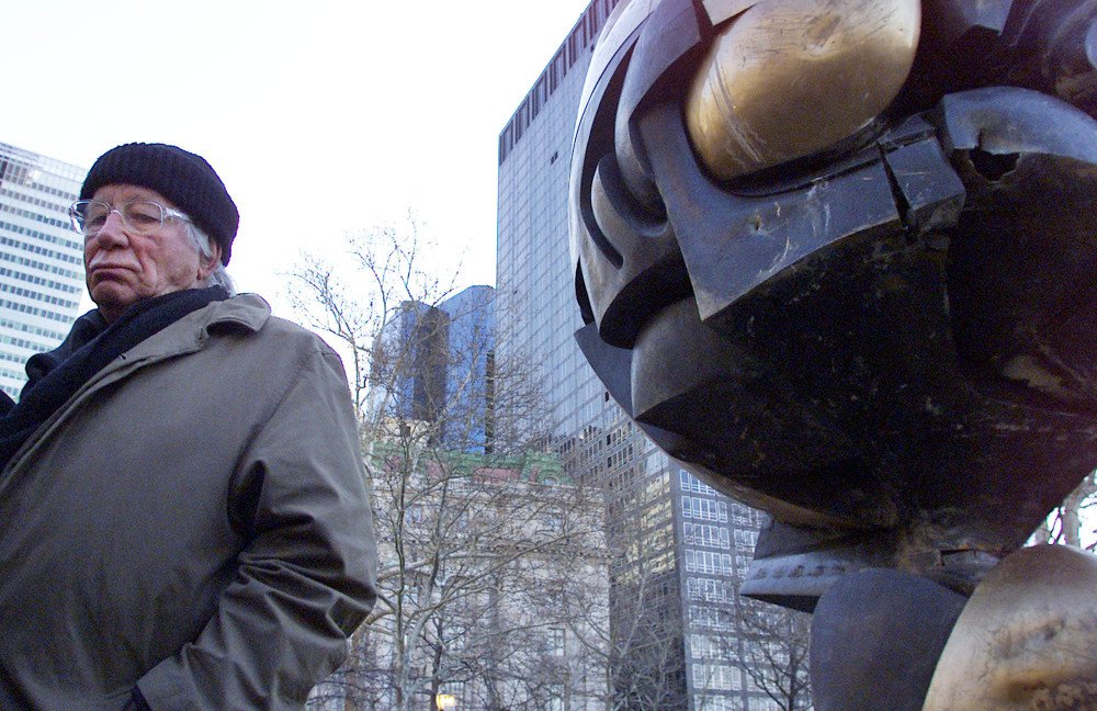 German artist Fritz Koenig stands next to his bronze sculpture "The Sphere" after a re-dedication ceremony in New York in 2002. Koenig, whose sculpture became a symbol of resilience after the Sept. 11 attacks in New York, died Wednesday at the afe of 92.