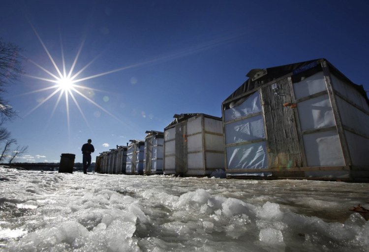 Tom Cowper of Peabody, Mass., walks from his ice fishing shack at Jim Worthing's Smelt Camp on the Kennebec River in Pittston while smelting in 2013. Fishermen and state regulators say the population of smelt appears to have made a comeback in 2017 after a down year in which few of them were caught.